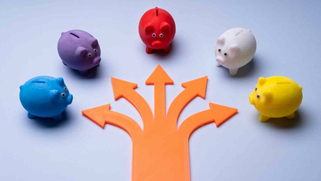 Arrows leading to lots of small piggy banks to illustrate small business marketing options and choices